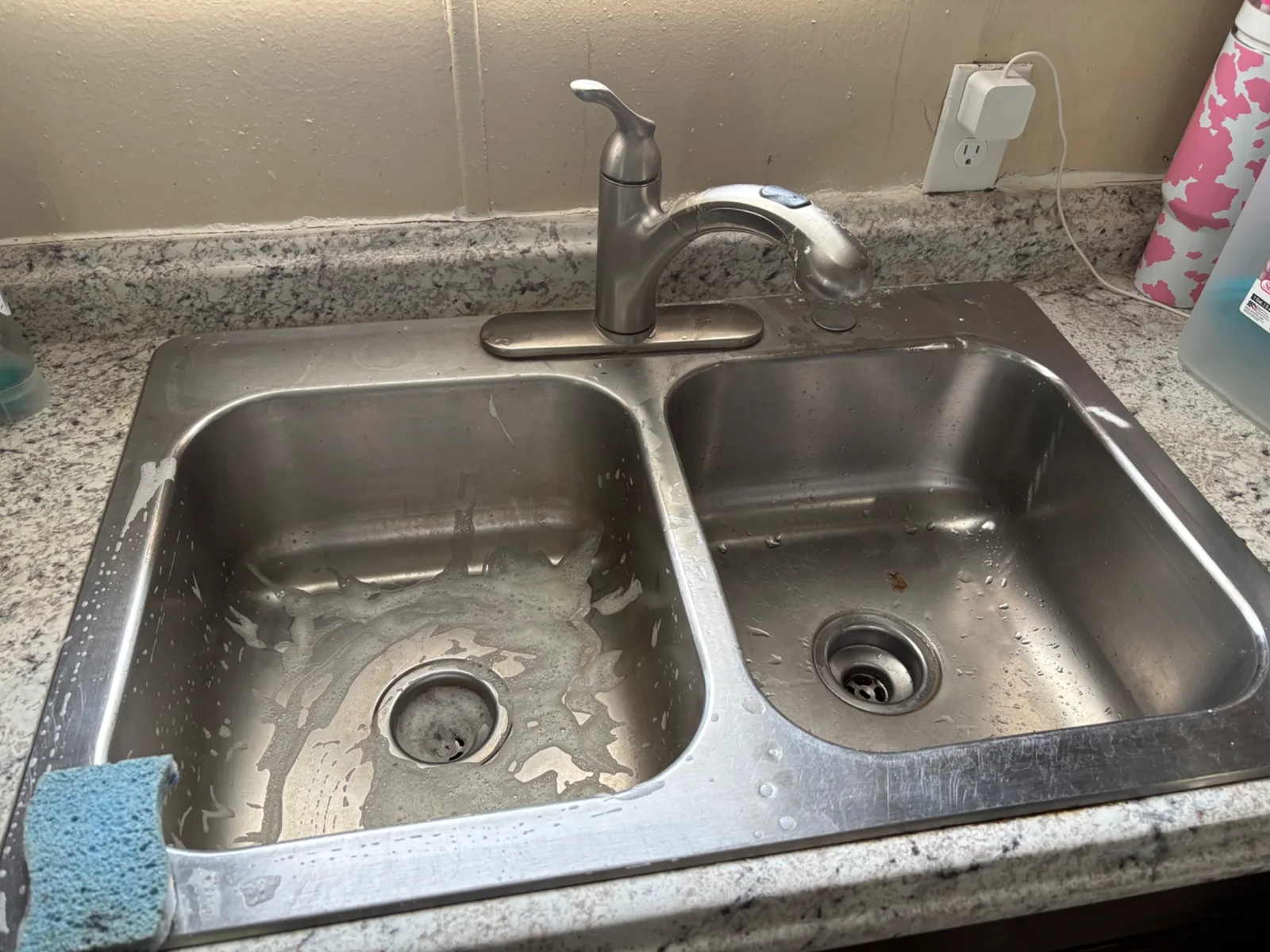Stainless steel kitchen sink before detailed cleaning, with ordinary water spots and everyday buildup
